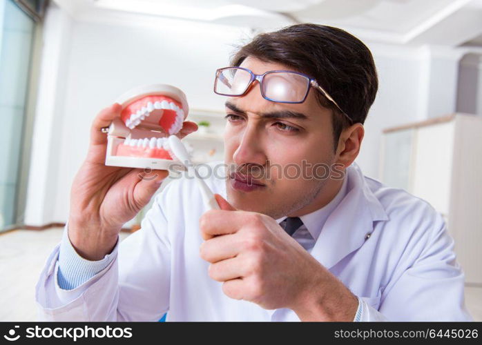 Funny dentist with toothbrush in medical concept