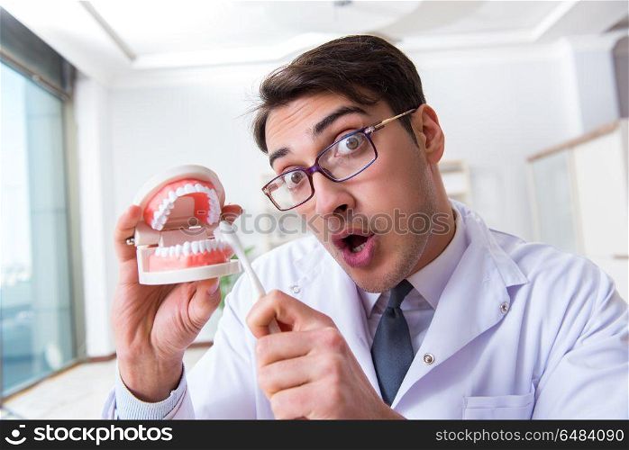 Funny dentist with toothbrush in medical concept