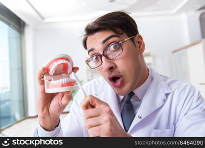 Funny dentist with toothbrush in medical concept