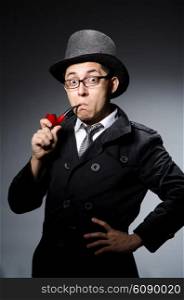 Funny detective with pipe and hat