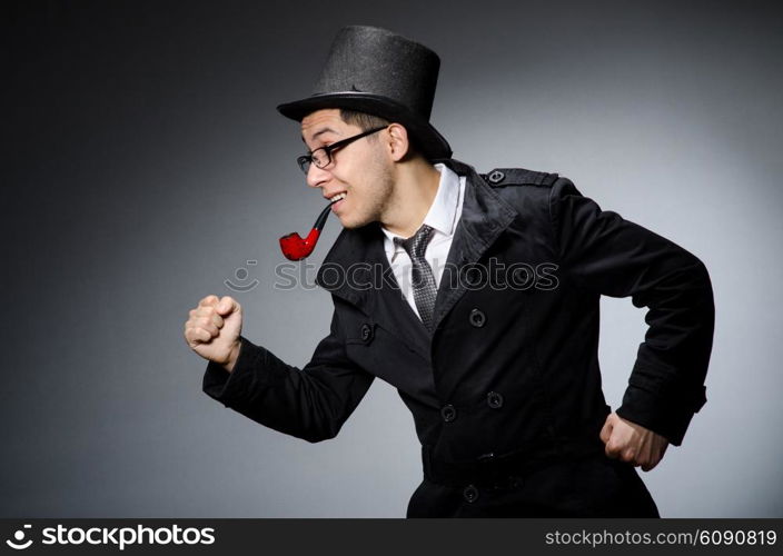 Funny detective with pipe and hat