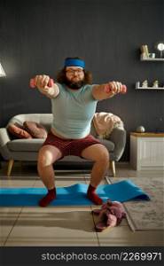 Funny fat man does morning workout with dumbbells at home. Sports, healthy lifestyle and weight loss. Funny man doing morning workout with dumbbells