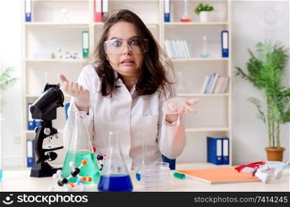 Funny female chemist working in the lab 