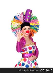 Funny girl clown with a big colorful wig saying Ok isolated on orange background