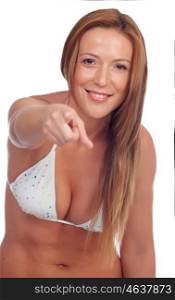 Funny girl in bikini indicating at camera isolated on a white background