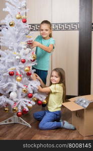 Funny girl remove Christmas decorations with Christmas tree. Funny girl remove Christmas decorations with artificial Christmas tree