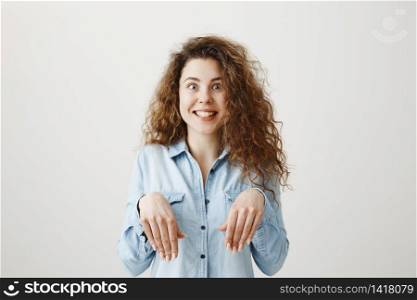 Funny girl showing bunny hands with her hands isolated on gray background.. Funny girl showing bunny hands with her hands isolated on gray background
