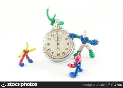 funny group of toys, playing with a clock, isolated on white