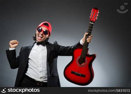 Funny guitar player in studio