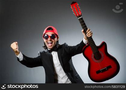 Funny guitar player in studio