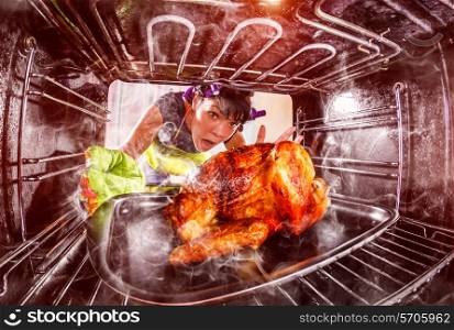 Funny Housewife overlooked roast chicken in the oven, so she had scorched , view from the inside of the oven. Housewife perplexed and angry. Loser is destiny!