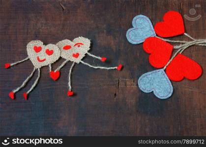 Funny idea with symbol of happy couple, hand in hand walking on pebble, sky with red cloud, group of red heart, Valentine day is happiness for lover