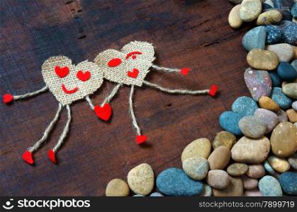 Funny idea with symbol of happy couple, hand in hand walking on pebble, sky with red cloud, group of red heart, Valentine day is happiness for lover