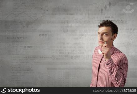 Funny image of young man looking in magnifying glass. Guy looking in magnifying glass
