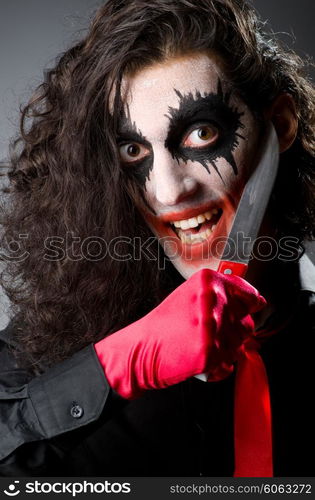 Funny joker with sharp knife