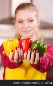 Funny joyful woman holding bell pepper delicious healthy dieting vegetable presenting diet food.. Happy woman holding bell peppers paprika