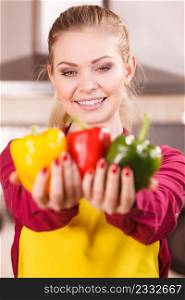 Funny joyful woman holding bell pepper delicious healthy dieting vegetable presenting diet food.. Happy woman holding bell peppers paprika
