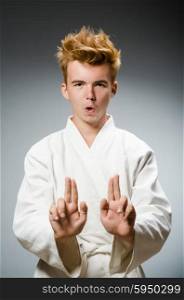 Funny karate fighter wearing white kimono