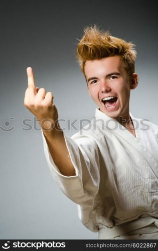 Funny karate fighter wearing white kimono