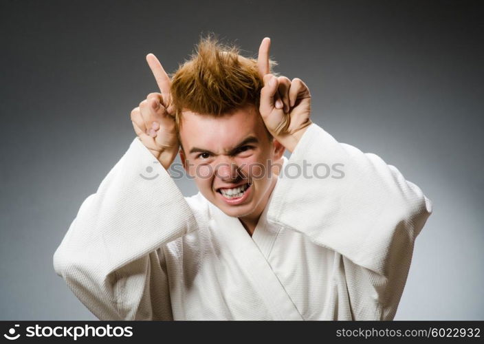 Funny karate fighter wearing white kimono