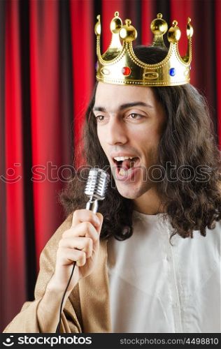 Funny king against red curtain
