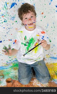 Funny little boy painted his hand with the background painted