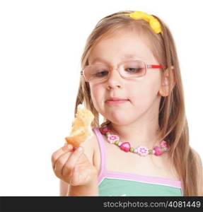 Funny little girl in glasses eating a bread doing fun isolated on white background. Happy childhood