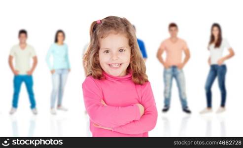 Funny little girl with casual young people of background unfocused