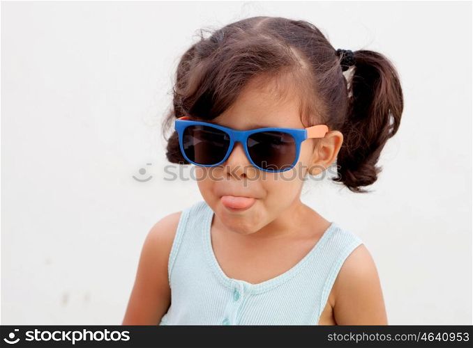 Funny little girl with pigtails and sunglasses outdoor
