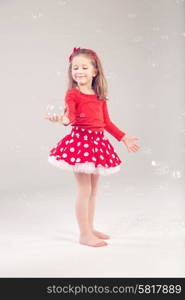 Funny, lovely little woman playing with soap bubbles