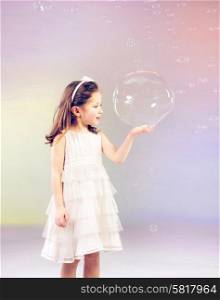 Funny lovely little woman playing with soap bubbles