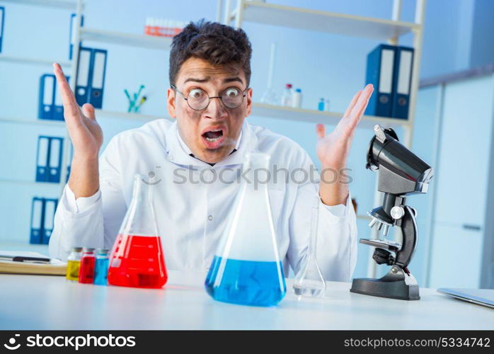 Funny mad chemist working in a laboratory