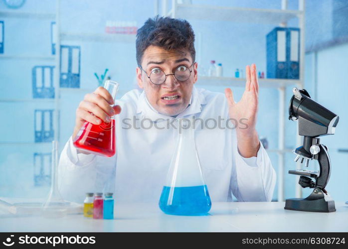 Funny mad chemist working in a laboratory