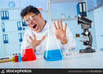 Funny mad chemist working in a laboratory