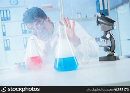 Funny mad chemist working in a laboratory