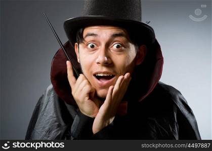 Funny magician man with wand and hat