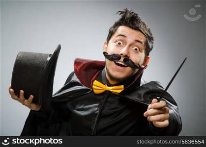 Funny magician man with wand and hat