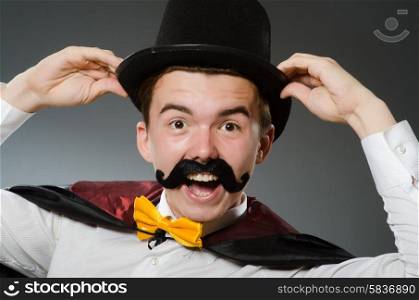 Funny magician with wand and hat