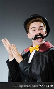Funny magician with wand and hat