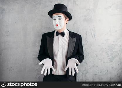 Funny male mime artist with makeup in gloves and hat. April fools day concept
