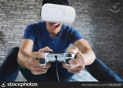 funny man enjoying a visual reality glasses in home