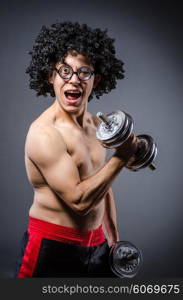 Funny man exercising with dumbbells