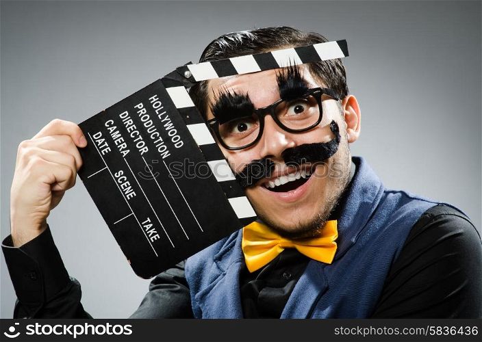 Funny man holding movie clapper
