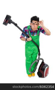 Funny man in green coveralls vacuum cleaning