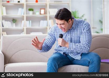 Funny man singing songs in karaoke at home