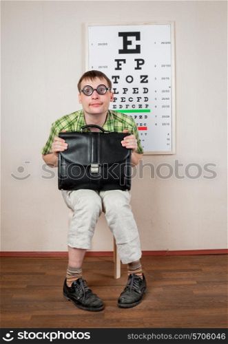 Funny man wearing spectacles in an office at the doctor