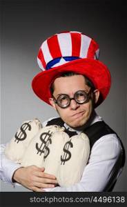 Funny man with american hat and sacks of money