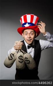 Funny man with american hat and sacks of money