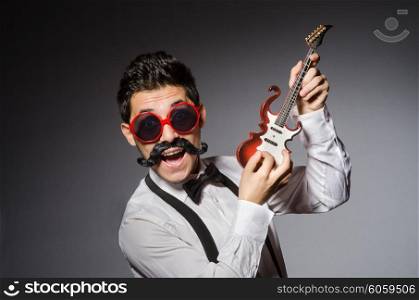Funny man with mini guitar