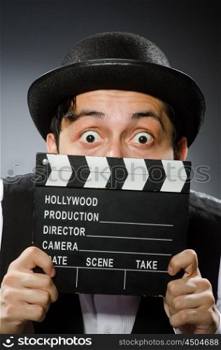 Funny man with movie clapper board